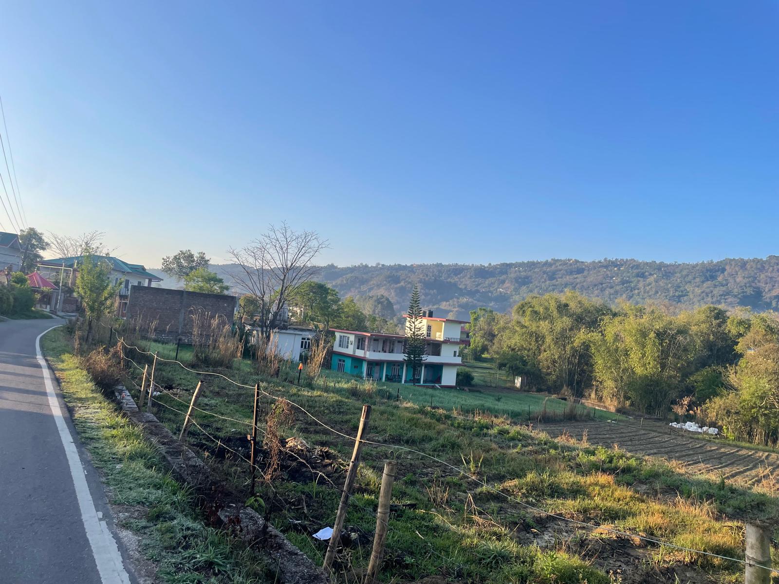 The village road and surrounding farmland near Sagoor Clinic